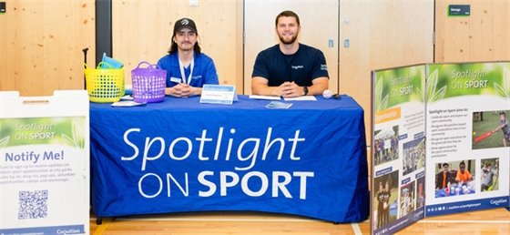 Spotlight on Sport booth with two volunteers stationed. 