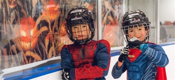 Two kids in costume skating