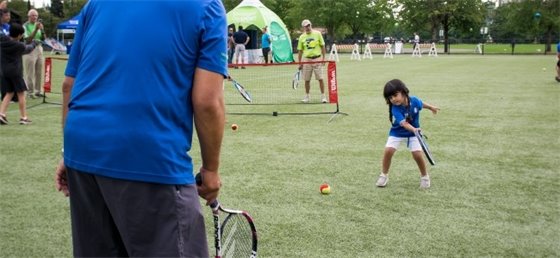 Adult and child playing tennis