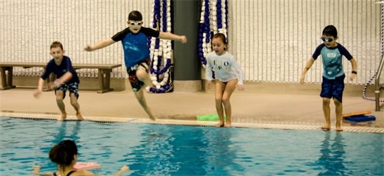 Kids jumping into the pool