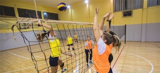 Youth playing volleyball