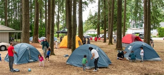 Families assembling tents