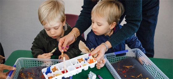 Two young boys participating in family arts and crafts.