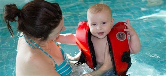 Parent swimming with child