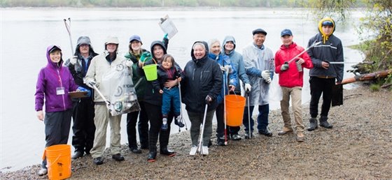 Volunteers performing shoreline clean up in Coquitlam.