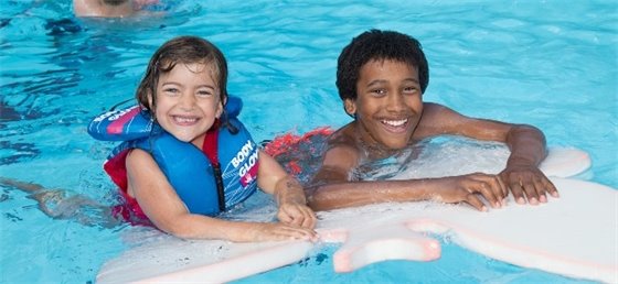 Two kids swimming in a pool