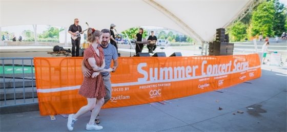 Two adults dancing during a concert