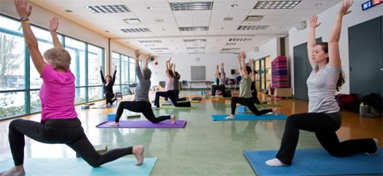 Adults participating in a Yoga class