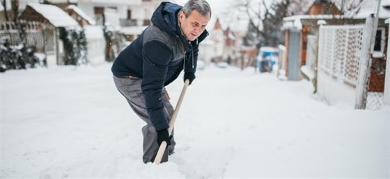 Adult shoveling snow