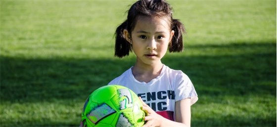 Child holding soccer ball
