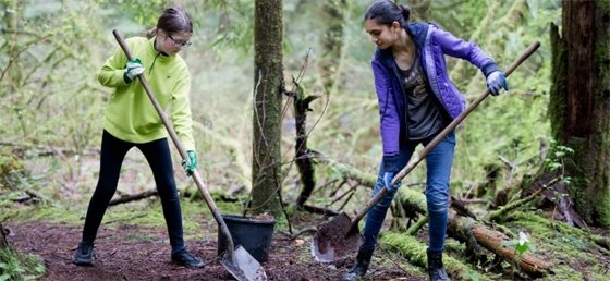 Two teens planting trees