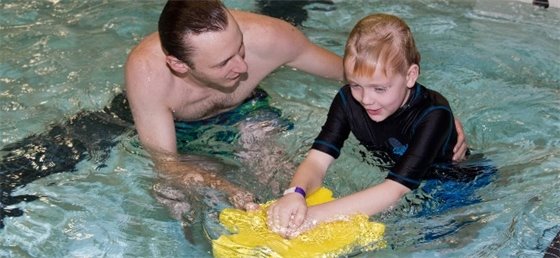 Swimming instructor and participant