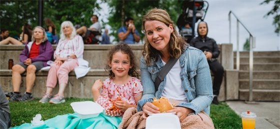Adult and child enjoying food truck fare