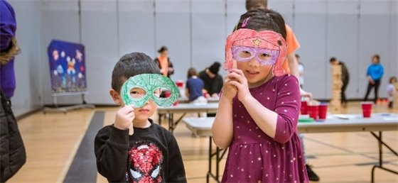 Two kids wearing artistic face masks
