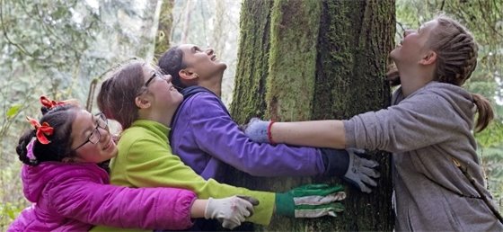 Youth hugging a tree