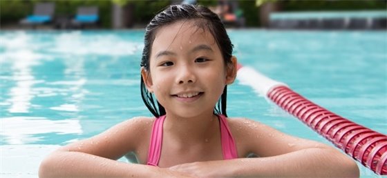 Girl swimming in outdoor pool 