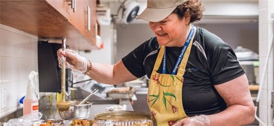 Volunteer making food