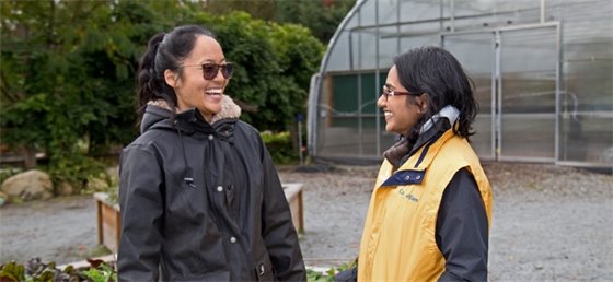Two adults laughing while standing in the garden