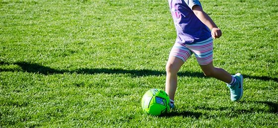 Child kicking a soccer ball