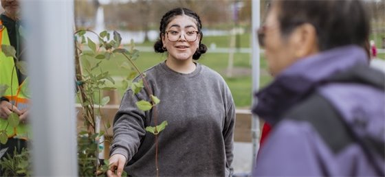 Volunteer helping give out free trees