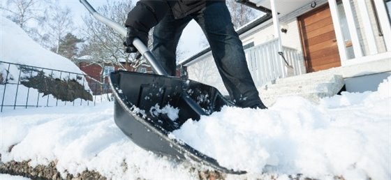 Adult shoveling snow