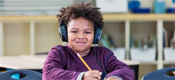 Child with noise-cancelling earphones on