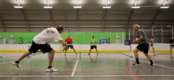 Adults playing pickleball