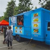 Blue food truck in parking lot
