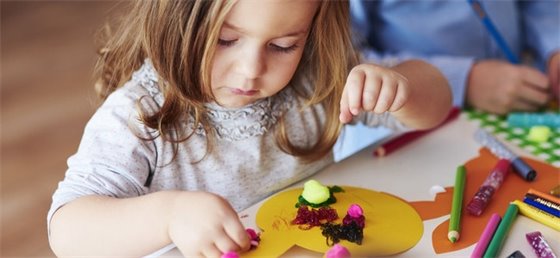 Young child enjoying Easter art crafts.