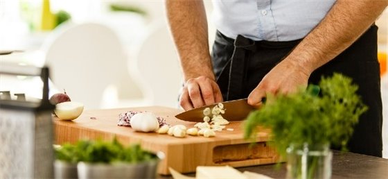 Adult chopping garlic