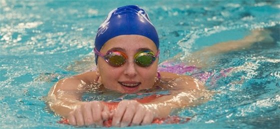 Child swimming in lessons