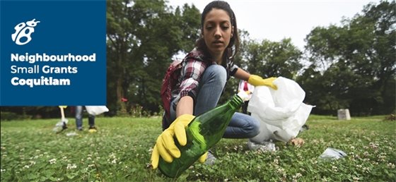 Adult picking up garbage on grass