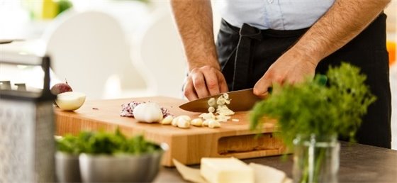 Adult cutting garlic