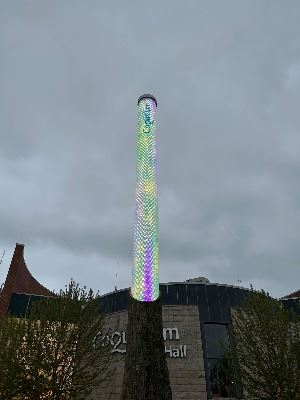 LED light column illuminated with purple, green, and gold.