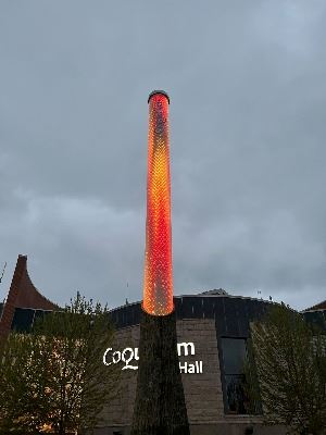 LED light column illuminated with orange, gold and red in the style of a flame.
