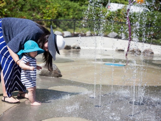 Parent and child at the spray park