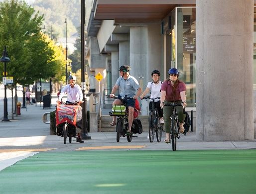 Multi modal transportation users at intersection waiting for green light