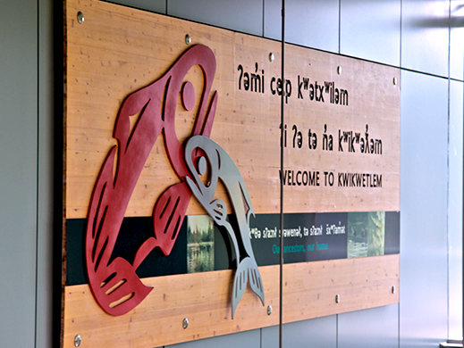 A photo of an indigenous art display that reads Welcome to Kwikwetlem