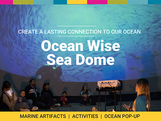 A group sitting under an Ocean Wise Display