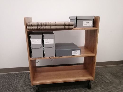 Archival records on trolley for research