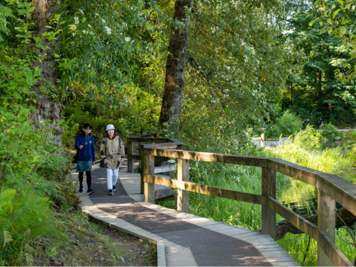 Two adults walking on the trail around Lafarge Lake