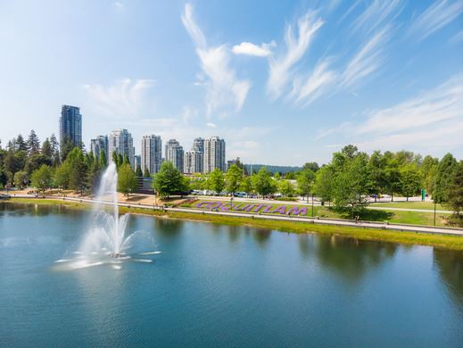 Aerial photo of Lafarge Lake looking west over Coquitlam with buildings in the background. 