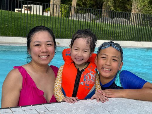 Parent and children swimming in the pool