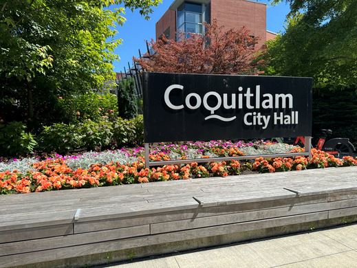 Image of City Hall sign surrounded by colourful flowers