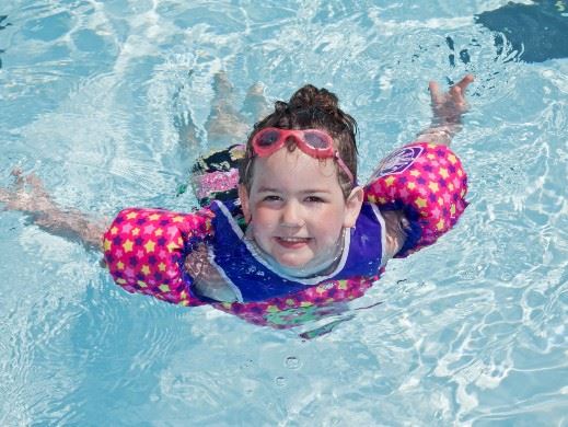 Girl swimming in outdoor pool