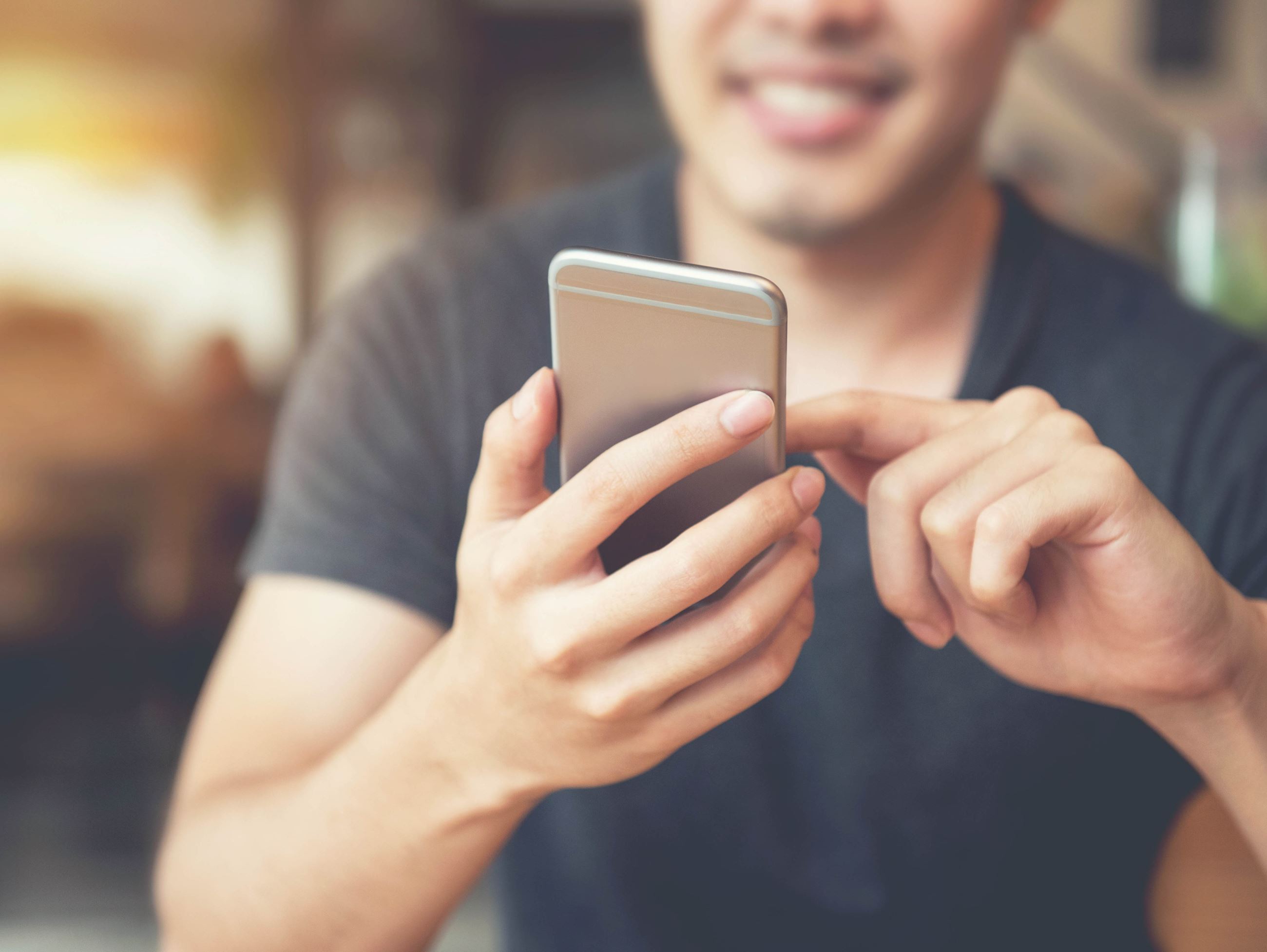 Happy man using smartphone