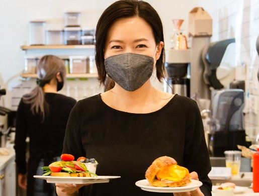 Adult holding plates of food