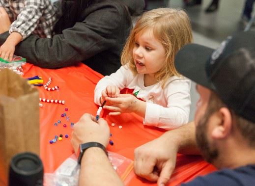 Child and adult making Christmas crafts together