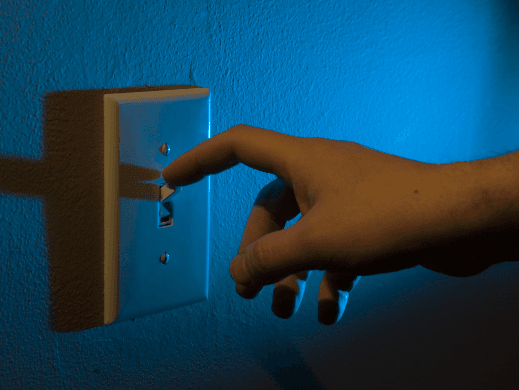 Hand turning off light