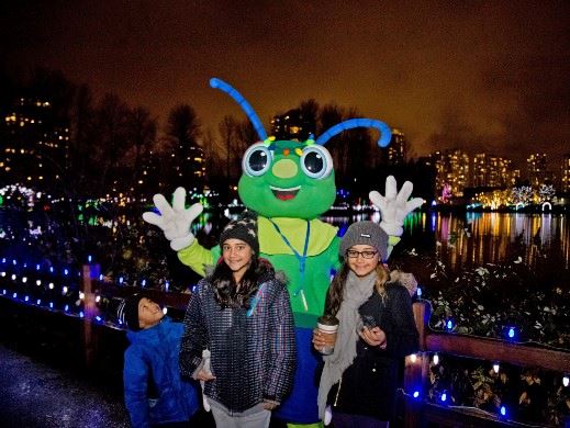 Sparky posing with kids at Lights at Lafarge